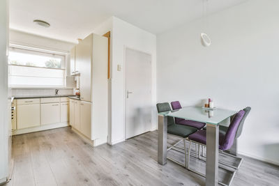 Empty chairs and table in living room