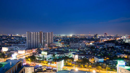 High angle view of illuminated buildings in city at night