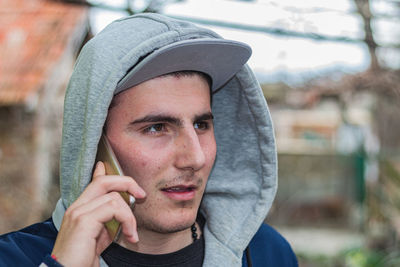 Portrait of man holding camera outdoors