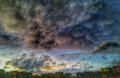 Cityscape against cloudy sky