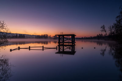 Scenic view of lake against sky during sunset