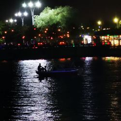 Silhouette boat in river at night