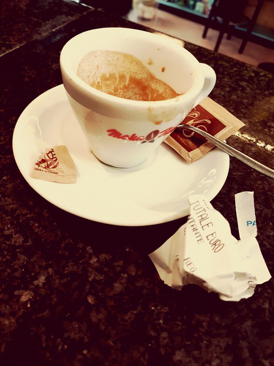 CLOSE-UP OF COFFEE CUP ON TABLE WITH SPOON