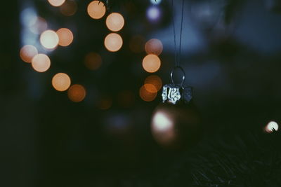 Close-up of decoration hanging on christmas tree at night