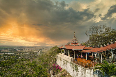 Panoramic shot of buildings against sky during sunset