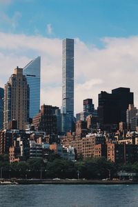 View of skyscrapers against cloudy sky