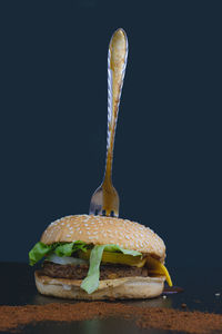 Close-up of bread on table against black background