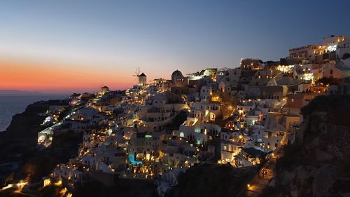 High angle view of illuminated buildings at sunset