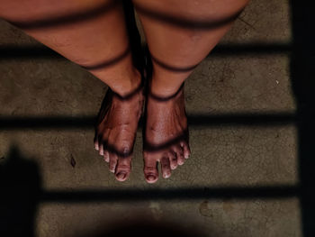 Low section of woman standing on tiled floor