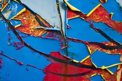 Close-up of multi colored umbrellas against blue sky