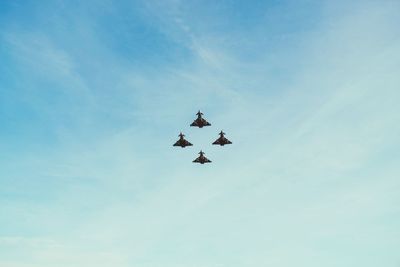 Low angle view of airplane flying against sky