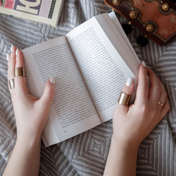 Midsection of woman reading book