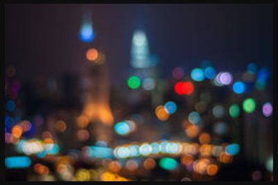 Defocused image of illuminated city at night