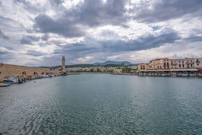 View of city by sea against sky