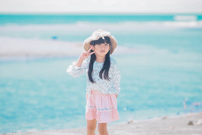 Full length of girl standing on beach