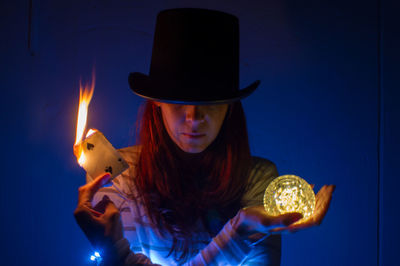 Midsection of woman wearing hat magic portrait 