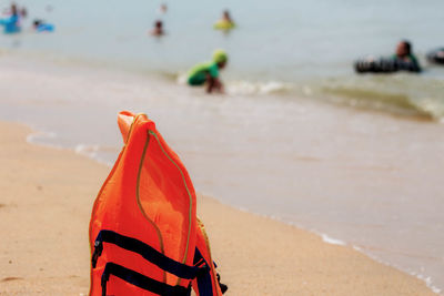 Close-up of life jacket at beach