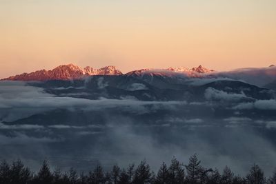 Scenic view of snowcapped mountains against sky during sunset