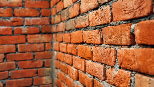 Brick wall under construction on nature background. red brick wall with diminishing perspective.