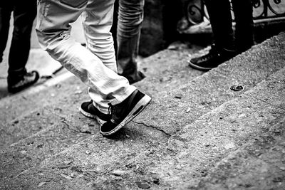 Low section of woman walking on tiled floor