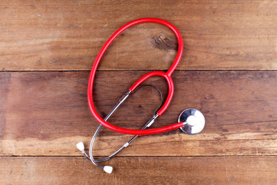 Directly above shot of red stethoscope on table