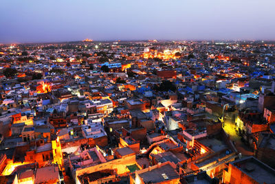 High angle view of illuminated town against sky during foggy weather