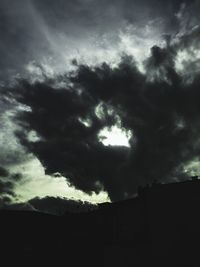 Low angle view of storm clouds over building