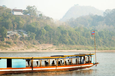 Scenic view of river by mountains