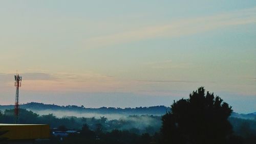 Smoke emitting from chimney against sky at sunset