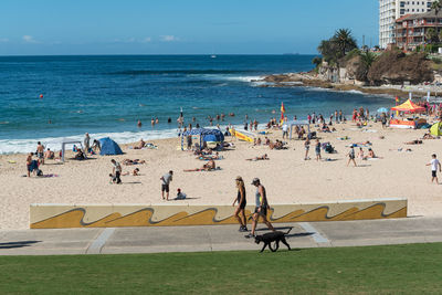 People at beach against sky