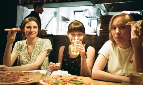 Portrait of females eating food