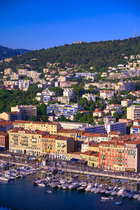 High angle view of townscape by canal against clear sky