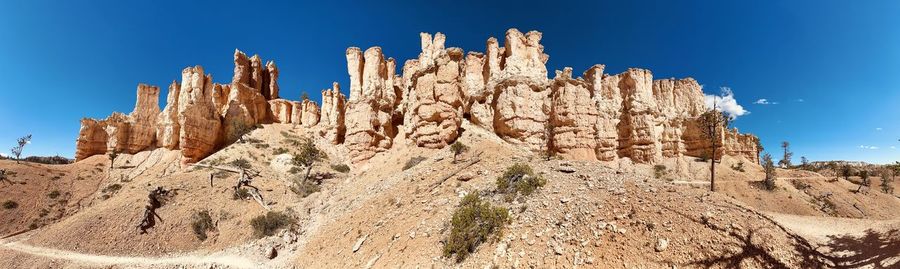 Low angle view of rock formations against sky