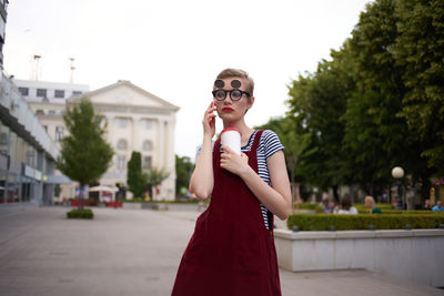 Young woman talking on phone while standing outdoors