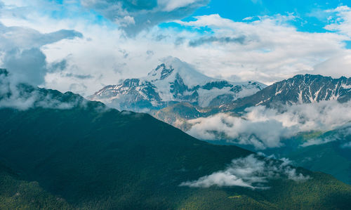 Scenic view of snowcapped mountains against sky