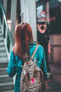 Rear view of woman standing outdoors