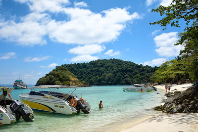 People on beach against sky