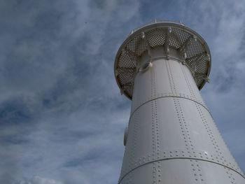 Low angle view of communications tower against sky