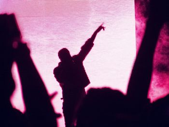 Low angle view of silhouette people standing against white background