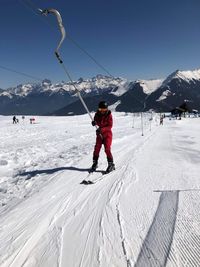 People skiing on snow covered landscape