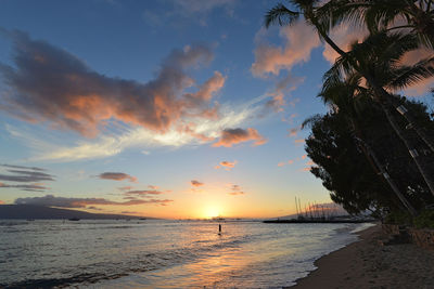 Scenic view of beach against sky during sunset