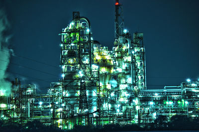 Low angle view of illuminated buildings against sky at night