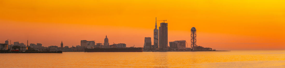 Scenic view of sea against orange sky