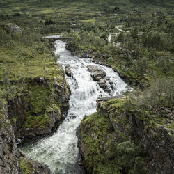 High angle view on waterfall against mountain range