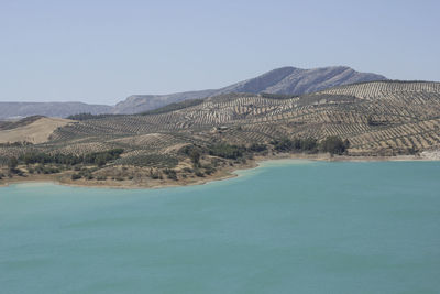 Scenic view of lake and mountains against sky