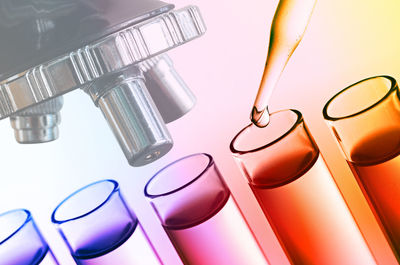 Close-up of scientific experiment over multicolored background