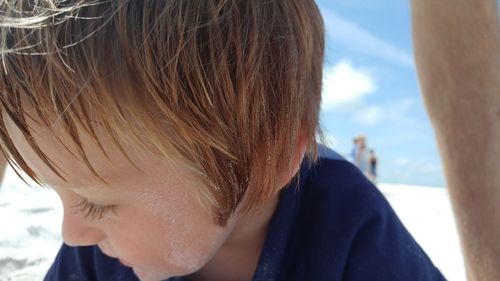 Close-up of boy against sky