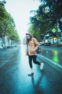 Man walking on road in city