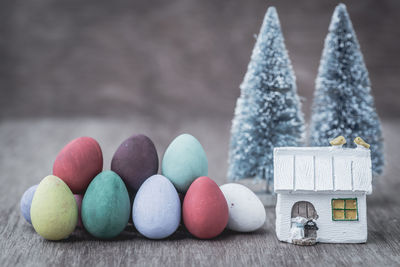 Close-up of colorful easter eggs by christmas decorations on table