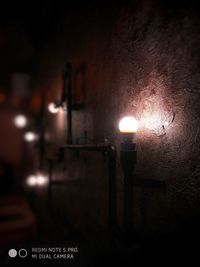 Close-up of illuminated lighting equipment on wall
